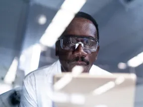 African American researcher looking at computer